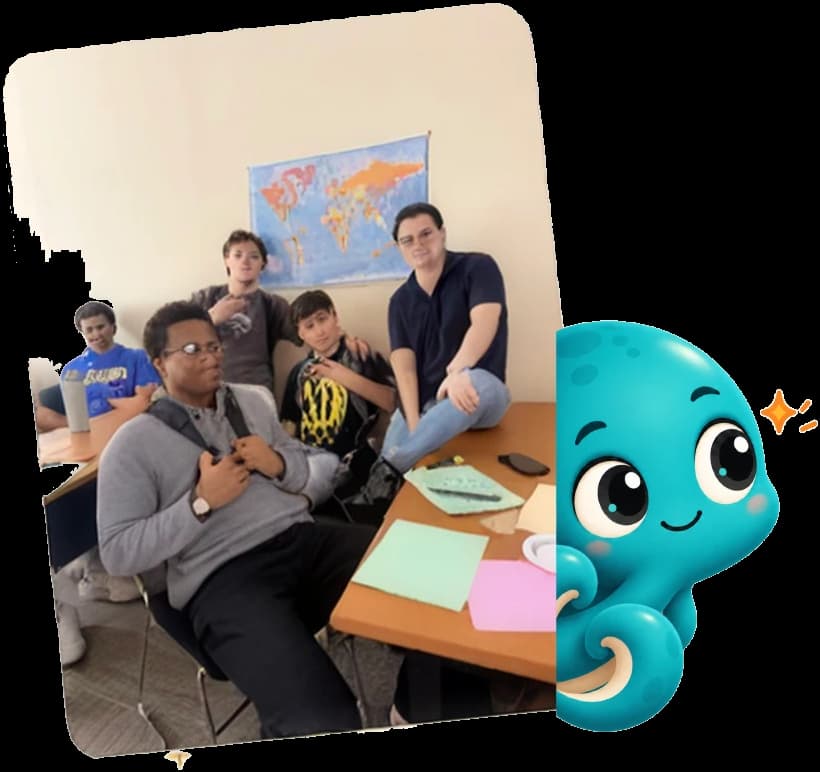 A group of We Glue students posing together in front of a world map, with Gluey the mascot peeking out from behind the photo