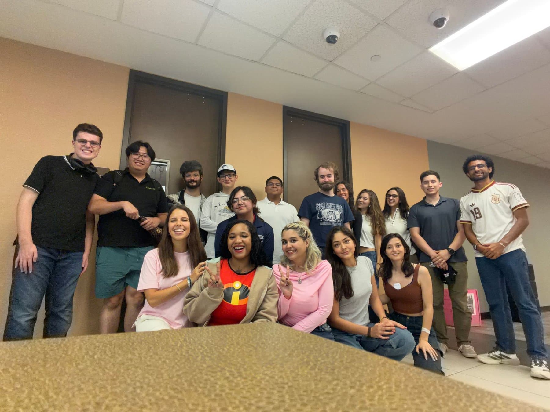 A large group of We Glue students posing together after a club meeting