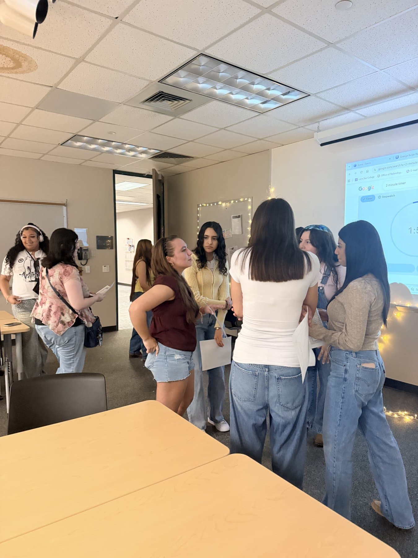 A group of We Glue students huddled together talking
